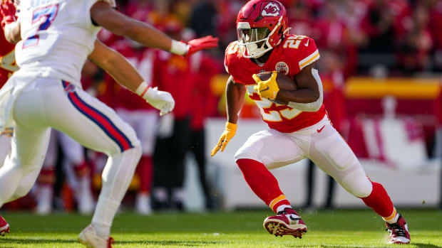 Oct 16, 2022; Kansas City, Missouri, USA; Kansas City Chiefs running back Clyde Edwards-Helaire (25) runs the ball as Buffalo Bills cornerback Taron Johnson (7) defends during the first half at GEHA Field at Arrowhead Stadium. Mandatory Credit: Jay Biggerstaff-USA TODAY Sports